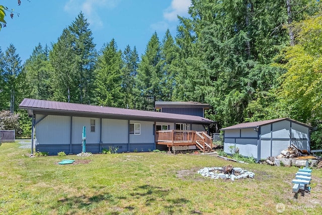 118 Silver Tip Ln, Packwood, WA 98361 - back of property featuring a lawn, a metal roof, and a view of trees