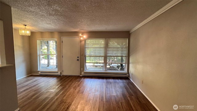 3425 S 176th St Unit 136, Seatac, WA 98188 - empty room featuring a textured ceiling, wood finished floors, a baseboard radiator, baseboards, and ornamental molding