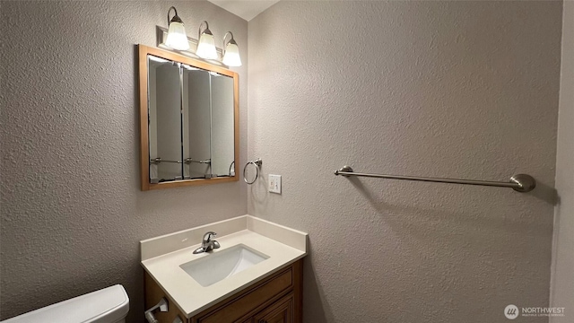 3425 S 176th St Unit 136, Seatac, WA 98188 - bathroom with toilet, vanity, and a textured wall
