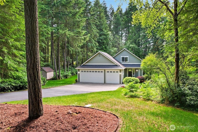 7302 Phillips Rd SE, Port Orchard, WA 98367 - traditional home with an attached garage, concrete driveway, a front lawn, and a view of trees