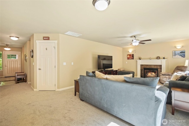 7302 Phillips Rd SE, Port Orchard, WA 98367 - living room with a tile fireplace, a ceiling fan, light carpet, and baseboards