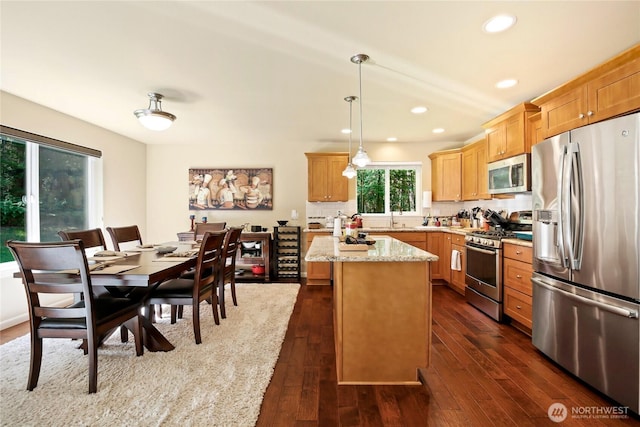 7302 Phillips Rd SE, Port Orchard, WA 98367 - kitchen featuring appliances with stainless steel finishes, a sink, dark wood finished floors, a kitchen island, and recessed lighting