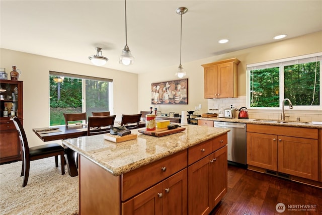 7302 Phillips Rd SE, Port Orchard, WA 98367 - kitchen featuring dishwasher, a sink, light stone counters, dark wood-style flooring, and a kitchen island