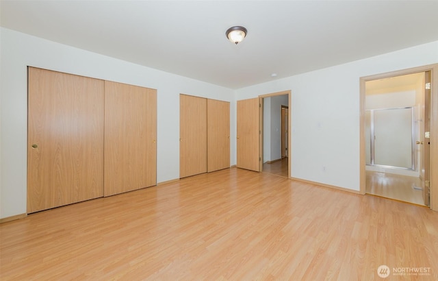 2715 99th Ave NE, Lake Stevens, WA 98258 - unfurnished bedroom featuring multiple closets and light wood-type flooring
