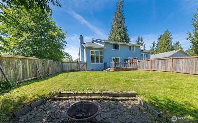 2715 99th Ave NE, Lake Stevens, WA 98258 - rear view of house with a fire pit, a fenced backyard, a chimney, crawl space, and a wooden deck