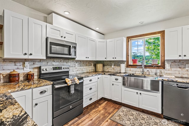 152 Simme Valley Ln, Winlock, WA 98596 - kitchen featuring appliances with stainless steel finishes, a sink, backsplash, stone counters, and recessed lighting