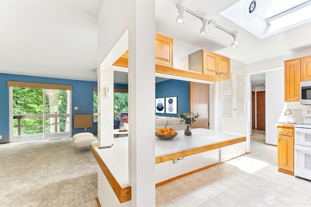 4012 NE 197th St, Lake Forest Park, WA 98155 - kitchen with white range with electric cooktop, light countertops, open floor plan, rail lighting, and light brown cabinetry