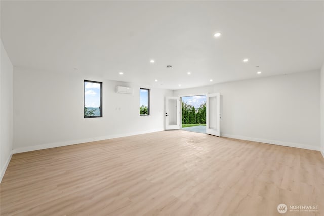 9418 165th Avenue Ct SW, Longbranch, WA 98351 - unfurnished room featuring recessed lighting, light wood finished floors, and an AC wall unit