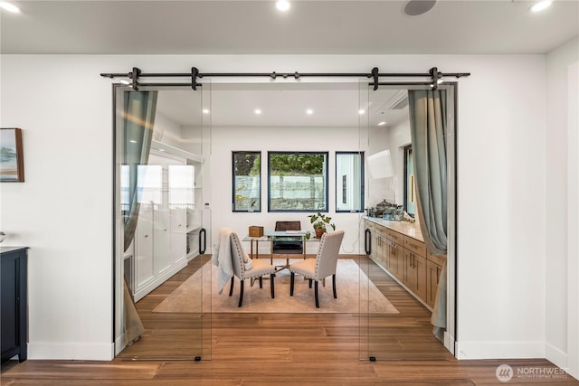 9418 165th Avenue Ct SW, Longbranch, WA 98351 - dining room featuring wood finished floors, recessed lighting, and a barn door