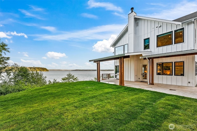 9418 165th Avenue Ct SW, Longbranch, WA 98351 - view of grassy yard with a water view and a patio