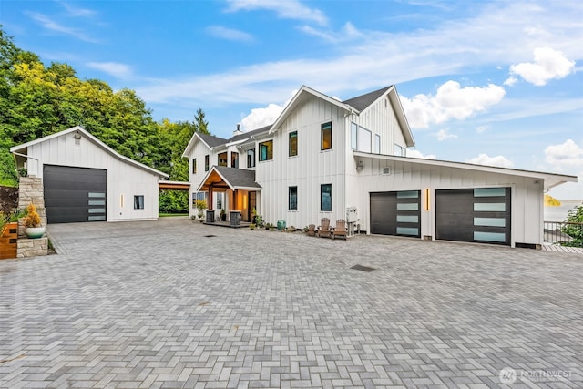 9418 165th Avenue Ct SW, Longbranch, WA 98351 - modern inspired farmhouse with board and batten siding, a garage, and driveway
