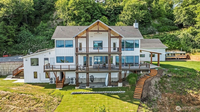 9418 165th Avenue Ct SW, Longbranch, WA 98351 - rear view of house featuring a balcony, a shingled roof, a yard, stairway, and a wooden deck