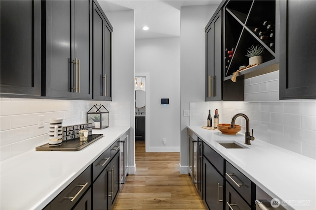 204 Moon River Vw SW, Mattawa, WA 99349 - indoor wet bar featuring baseboards, light wood-style flooring, decorative backsplash, recessed lighting, and wine cooler