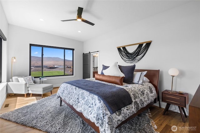 204 Moon River Vw SW, Mattawa, WA 99349 - bedroom featuring wood finished floors, a barn door, baseboards, recessed lighting, and ceiling fan
