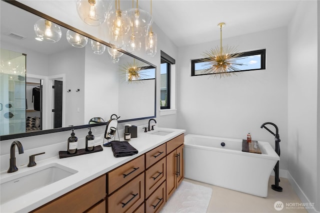 204 Moon River Vw SW, Mattawa, WA 99349 - full bathroom with a chandelier, a freestanding bath, double vanity, a shower stall, and tile patterned flooring