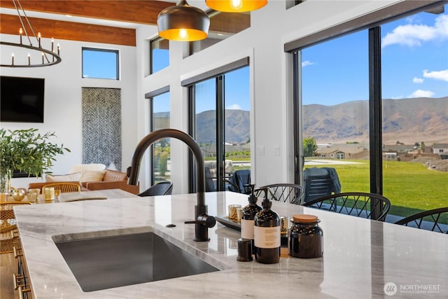 204 Moon River Vw SW, Mattawa, WA 99349 - kitchen featuring a mountain view, stone countertops, beam ceiling, hanging light fixtures, and open floor plan