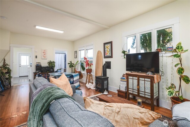 1612 7th St, Anacortes, WA 98221 - living area featuring healthy amount of natural light, wood finished floors, a wood stove, and baseboards