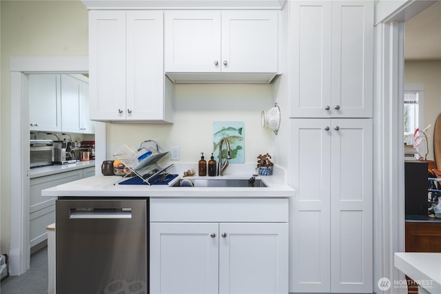 1612 7th St, Anacortes, WA 98221 - kitchen featuring stainless steel dishwasher, a sink, light countertops, and white cabinetry