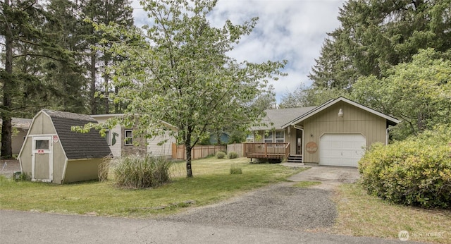 401 Draconis Ave SE, Ocean Shores, WA 98569 - view of front facade featuring asphalt driveway, an attached garage, a deck, an outbuilding, and roof with shingles
