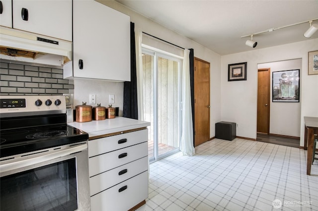 401 Draconis Ave SE, Ocean Shores, WA 98569 - kitchen featuring stainless steel range with electric cooktop, under cabinet range hood, light countertops, white cabinets, and rail lighting