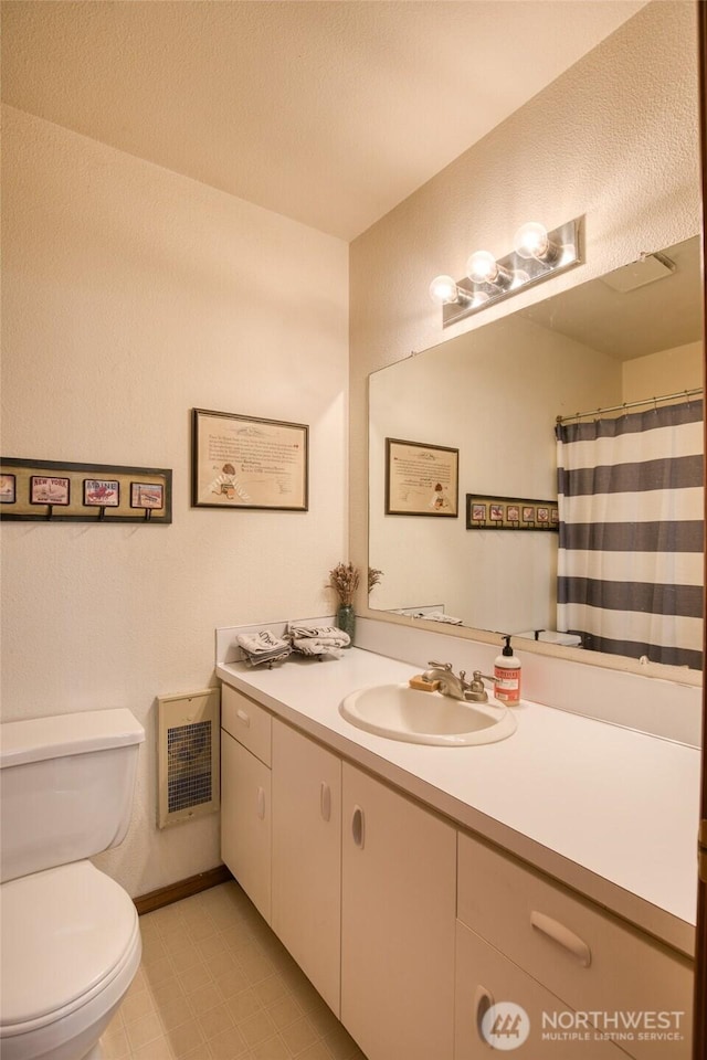 401 Draconis Ave SE, Ocean Shores, WA 98569 - bathroom with vanity, toilet, and tile patterned flooring