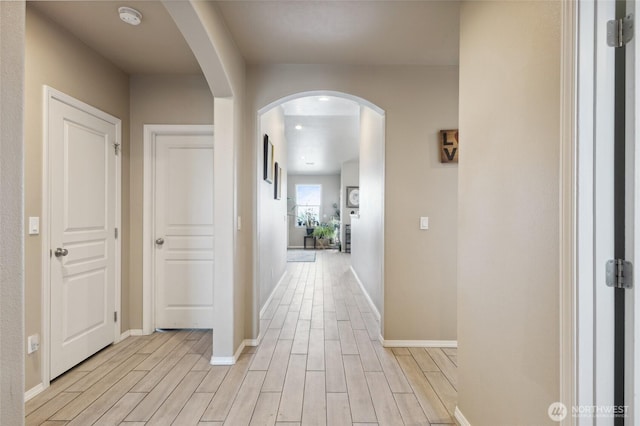 7186 16th Rd NE, Moses Lake, WA 98837 - hall featuring arched walkways, light wood-style floors, and baseboards