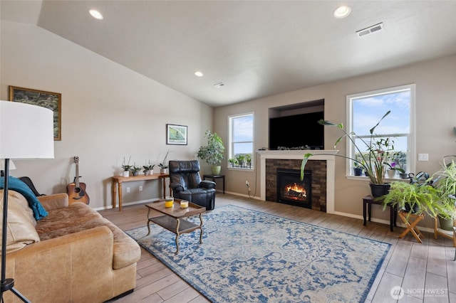 7186 16th Rd NE, Moses Lake, WA 98837 - living room with vaulted ceiling, a lit fireplace, light wood finished floors, baseboards, and recessed lighting