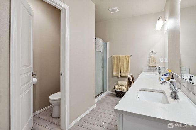 7186 16th Rd NE, Moses Lake, WA 98837 - bathroom with toilet, double vanity, wood finished floors, a stall shower, and baseboards