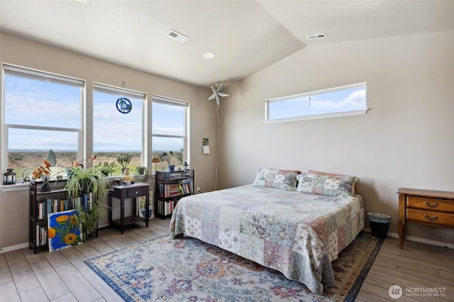 7186 16th Rd NE, Moses Lake, WA 98837 - bedroom featuring wood finished floors, multiple windows, lofted ceiling, and baseboards