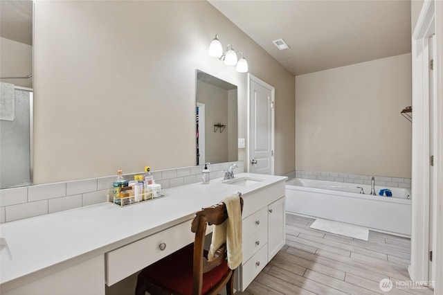 7186 16th Rd NE, Moses Lake, WA 98837 - full bathroom featuring vanity, a bath, and wood finished floors
