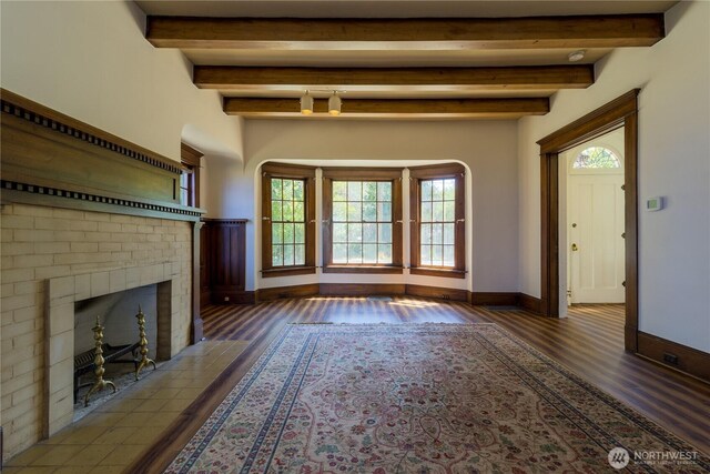 244 Marcus St, Walla Walla, WA 99362 - unfurnished living room with wood finished floors, a brick fireplace, and beamed ceiling