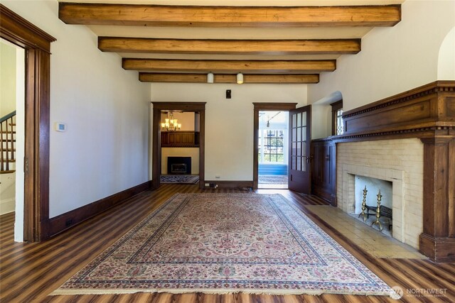 244 Marcus St, Walla Walla, WA 99362 - unfurnished living room with a brick fireplace, beam ceiling, wood finished floors, a chandelier, and stairway