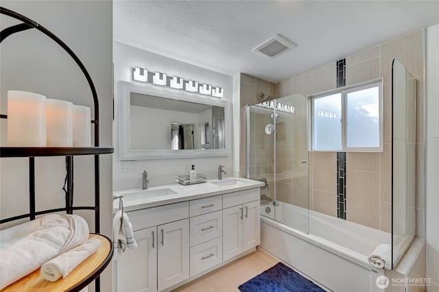 10825 Marine View Dr SW, Seattle, WA 98146 - full bathroom featuring double vanity, enclosed tub / shower combo, and tile patterned floors