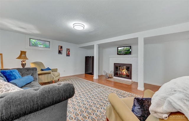 10825 Marine View Dr SW, Seattle, WA 98146 - living room featuring wood finished floors, a fireplace, and baseboards
