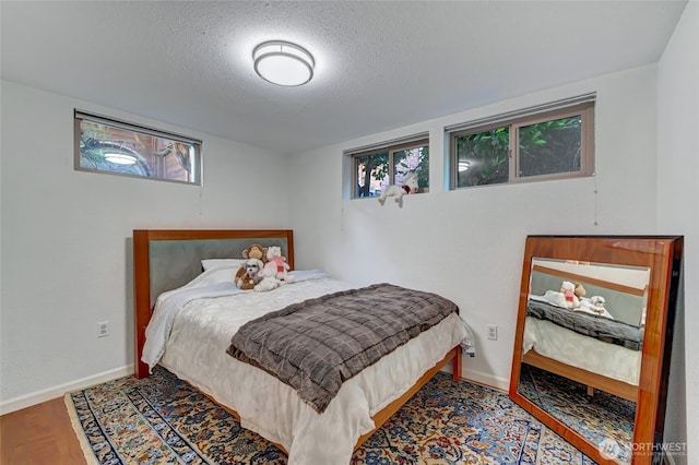 10825 Marine View Dr SW, Seattle, WA 98146 - bedroom with a textured ceiling, wood finished floors, and baseboards