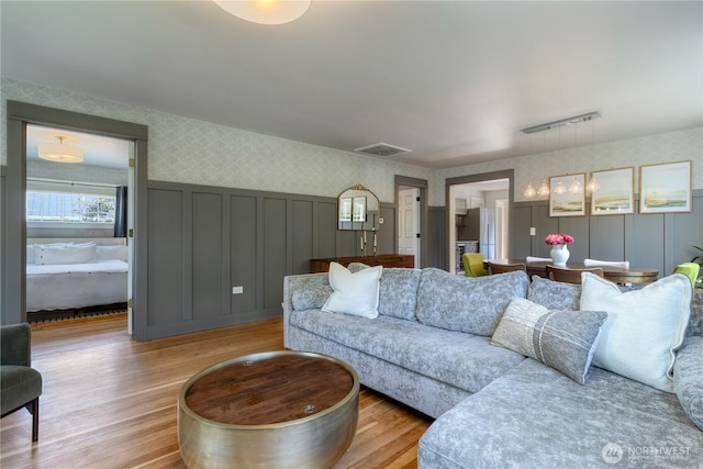 515 S Division St, Walla Walla, WA 99362 - living area with wallpapered walls, light wood-type flooring, a decorative wall, and a wainscoted wall