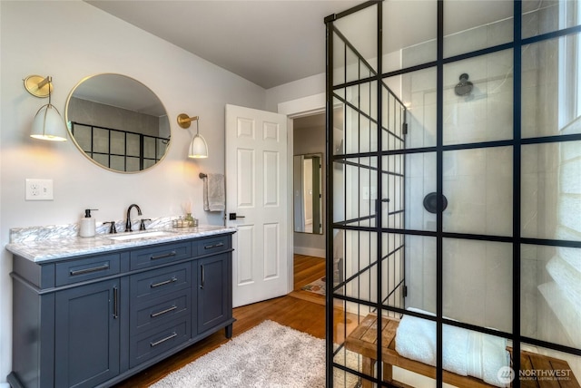 515 S Division St, Walla Walla, WA 99362 - bathroom featuring wood finished floors, vanity, and tiled shower