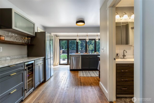 515 S Division St, Walla Walla, WA 99362 - kitchen featuring appliances with stainless steel finishes, wine cooler, hardwood / wood-style flooring, light countertops, and open shelves
