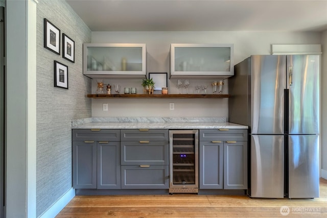 515 S Division St, Walla Walla, WA 99362 - indoor dry bar featuring freestanding refrigerator, wine cooler, light wood-style flooring, and wallpapered walls