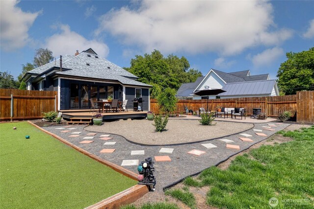 515 S Division St, Walla Walla, WA 99362 - rear view of house featuring a deck, a patio, a fenced backyard, and a shingled roof