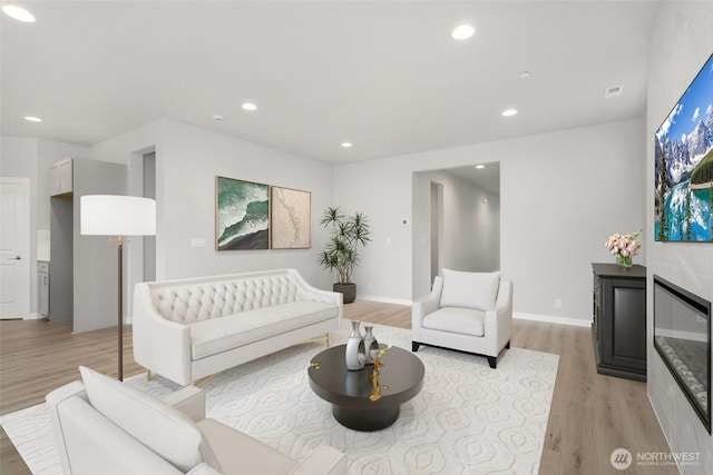 13307 SE 238th Pl Unit 11, Kent, WA 98042 - living area with light wood finished floors, recessed lighting, a glass covered fireplace, and baseboards