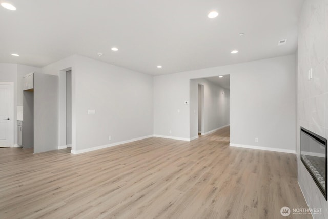 13307 SE 238th Pl Unit 11, Kent, WA 98042 - unfurnished living room with light wood-type flooring, recessed lighting, baseboards, and a tiled fireplace