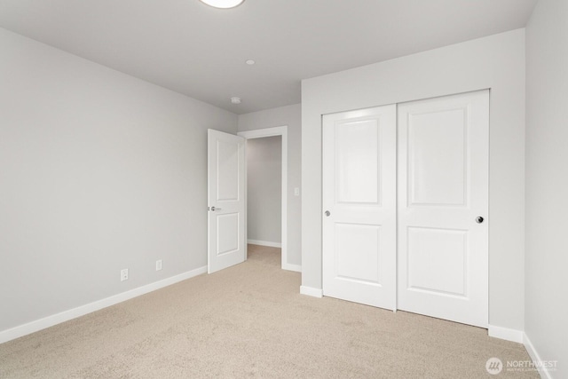 13307 SE 238th Pl Unit 11, Kent, WA 98042 - unfurnished bedroom featuring light colored carpet, baseboards, and a closet
