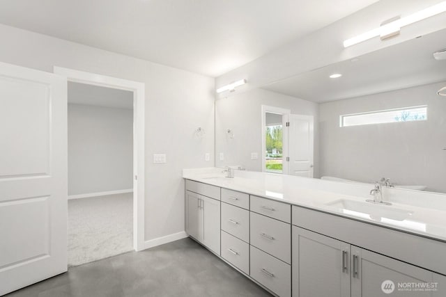 13307 SE 238th Pl Unit 11, Kent, WA 98042 - bathroom with double vanity, baseboards, concrete floors, and recessed lighting