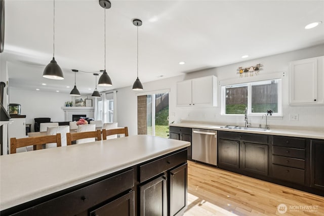 15503 39th Ave SE, Bothell, WA 98012 - kitchen with dishwasher, light countertops, white cabinets, light wood-style flooring, and recessed lighting