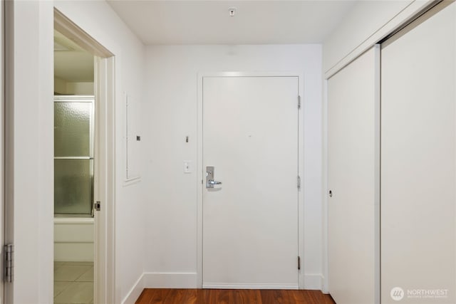 2911 2nd Ave Unit 522, Seattle, WA 98121 - hallway with baseboards and dark wood-type flooring