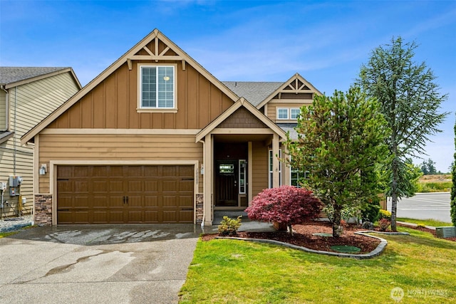 10089 Jensen Dr SE, Yelm, WA 98597 - craftsman house featuring board and batten siding, a front yard, driveway, a garage, and stone siding