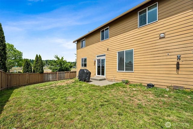 10089 Jensen Dr SE, Yelm, WA 98597 - back of house with a fenced backyard and a patio area