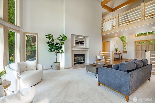 5520 Canvasback Rd, Blaine, WA 98230 - living area with a high ceiling, carpet, baseboards, and a tiled fireplace