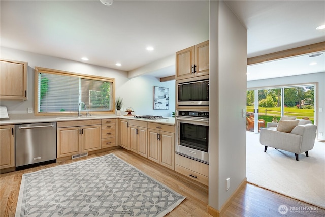 5520 Canvasback Rd, Blaine, WA 98230 - kitchen with appliances with stainless steel finishes, a sink, light brown cabinets, light wood-style flooring, and recessed lighting